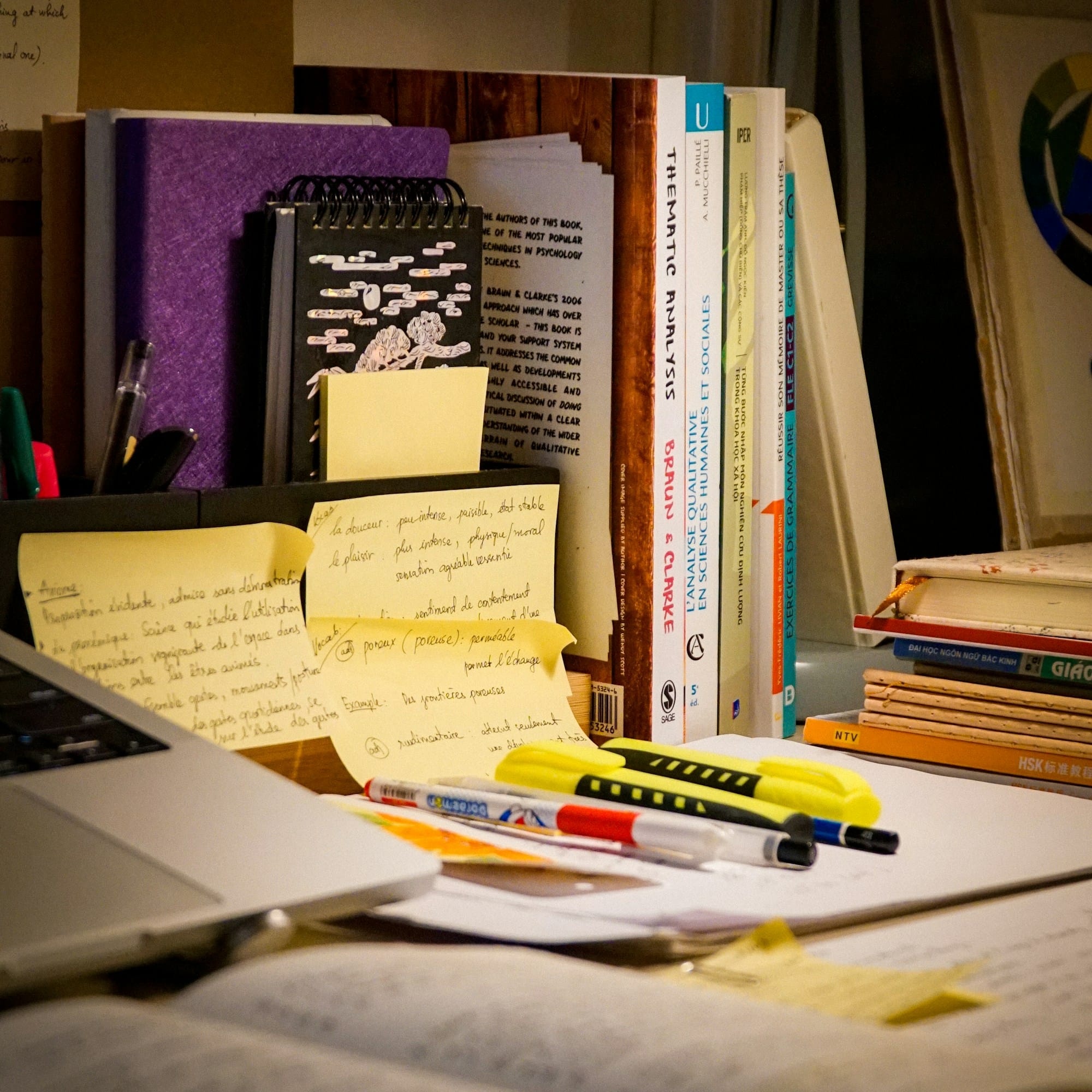 Open book and laptop desk for IB English tutoring article